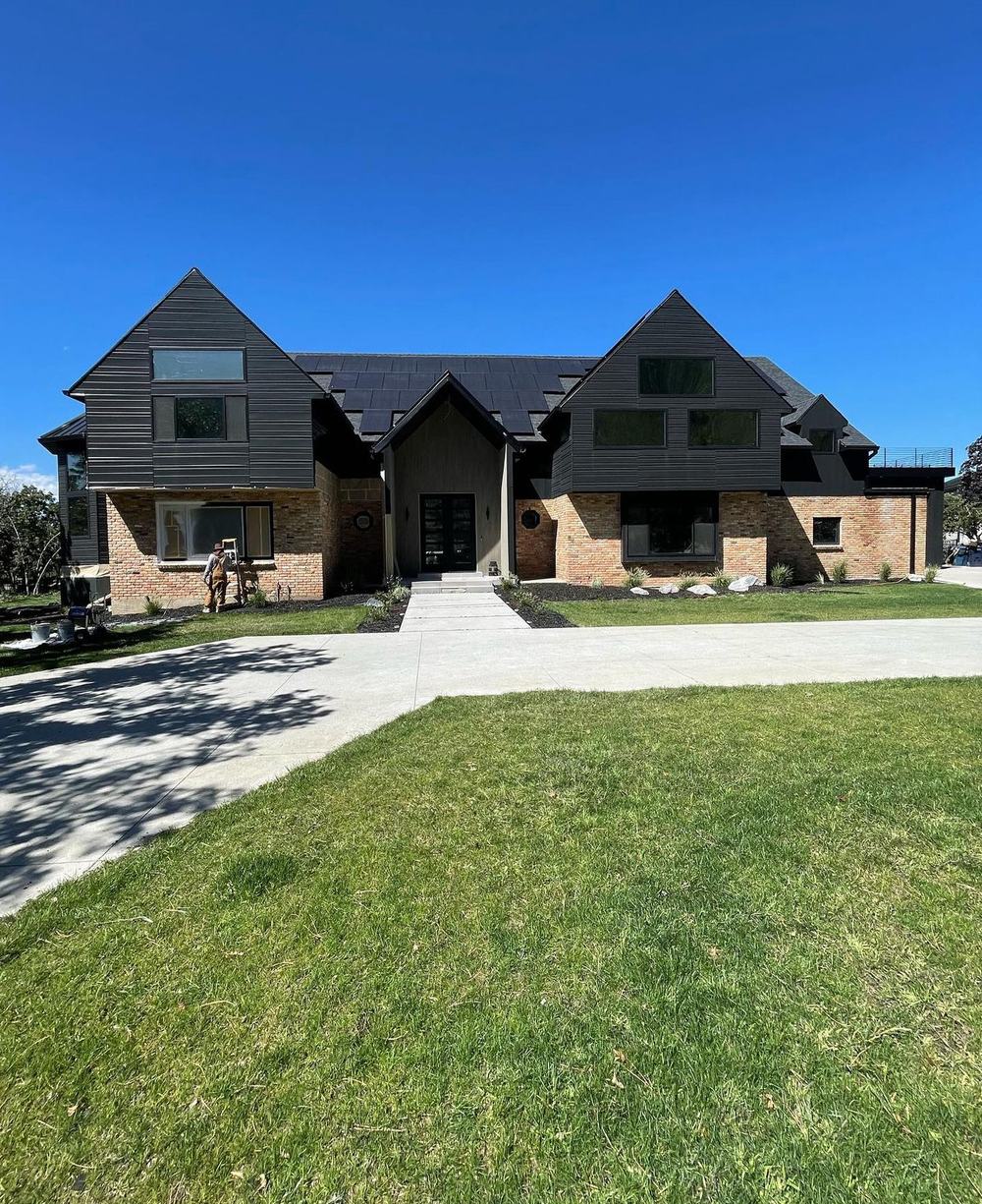 Finished modern black exterior home, second angle