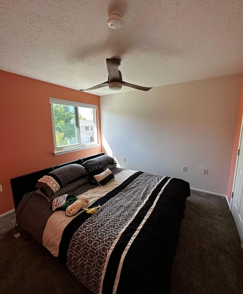 Finished bedroom with orange and gray accent walls, Valley Painters LLC