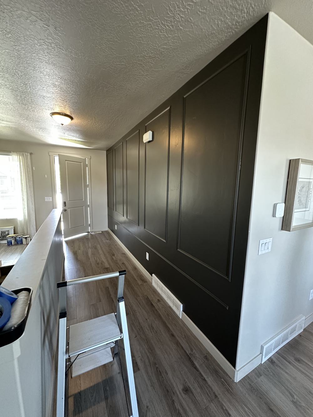 Finished dark wainscoting accent wall hallway