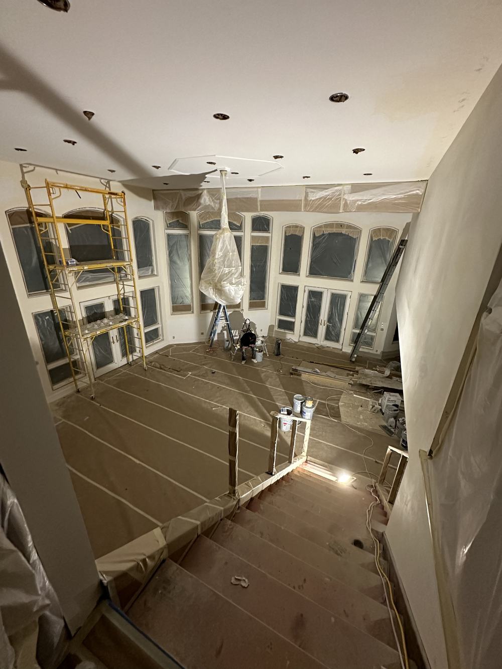 Large great room prepped and covered for painting