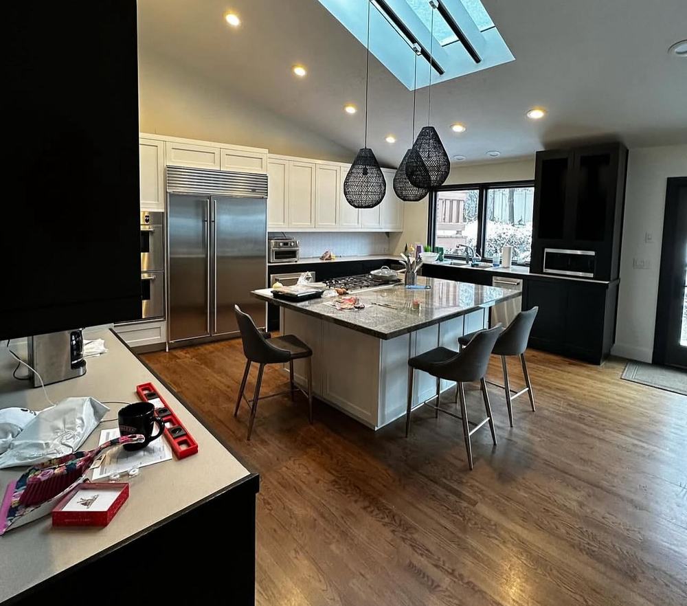 Finished kitchen with skylight and dark cabinets