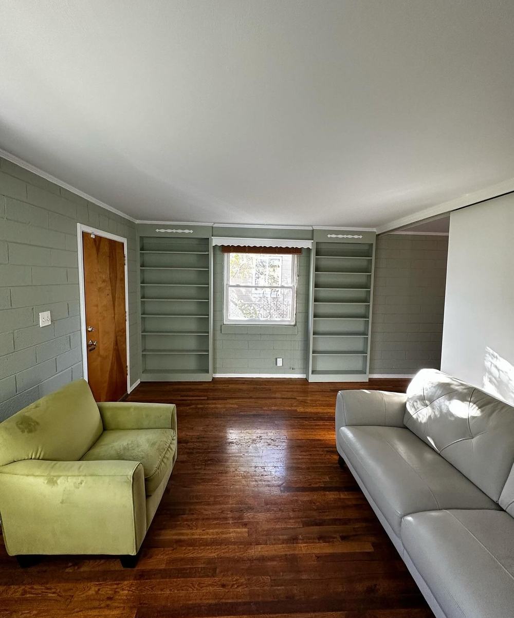 Sage green painted brick room before furnishing